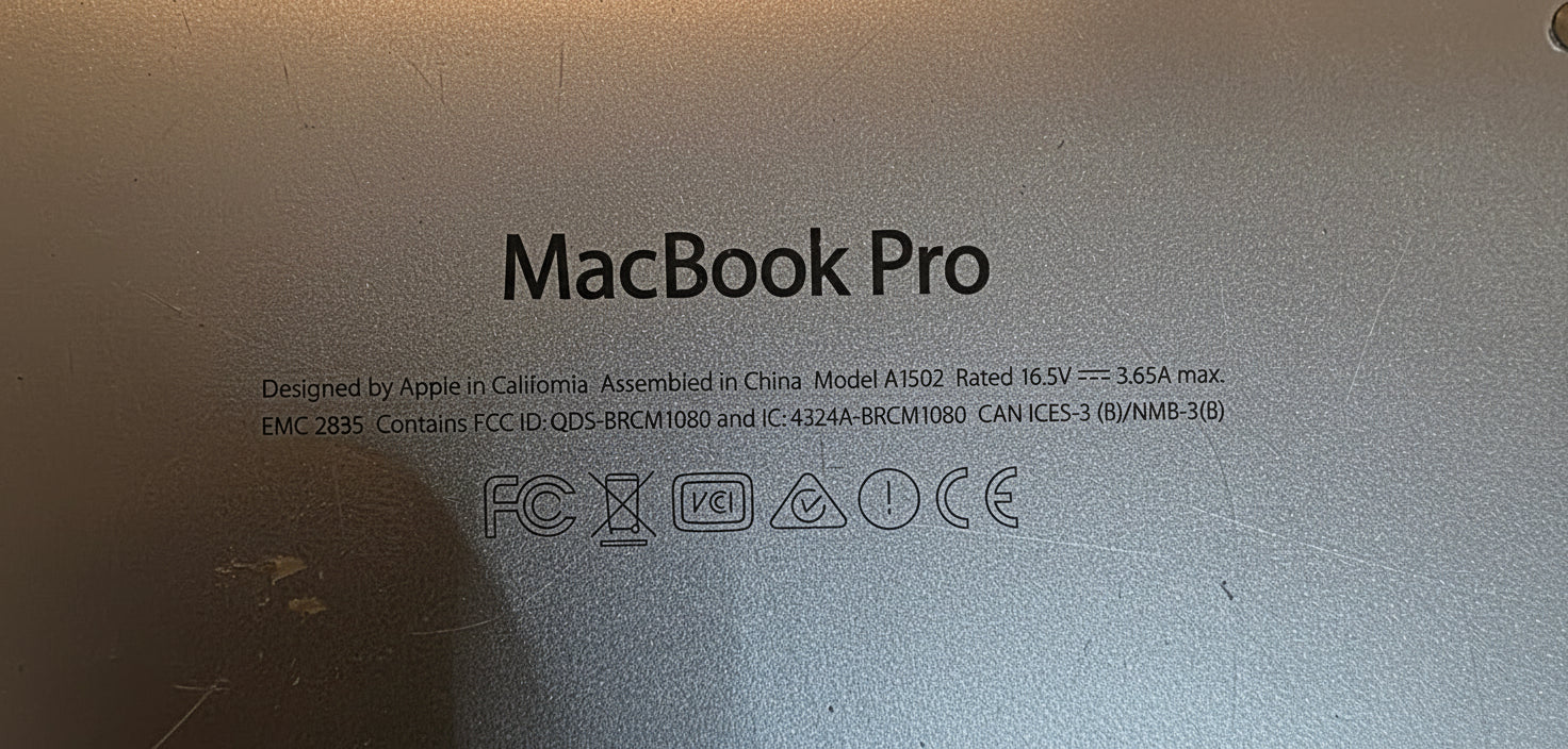 Close-up of a MacBook Pro lid with branding and model information.