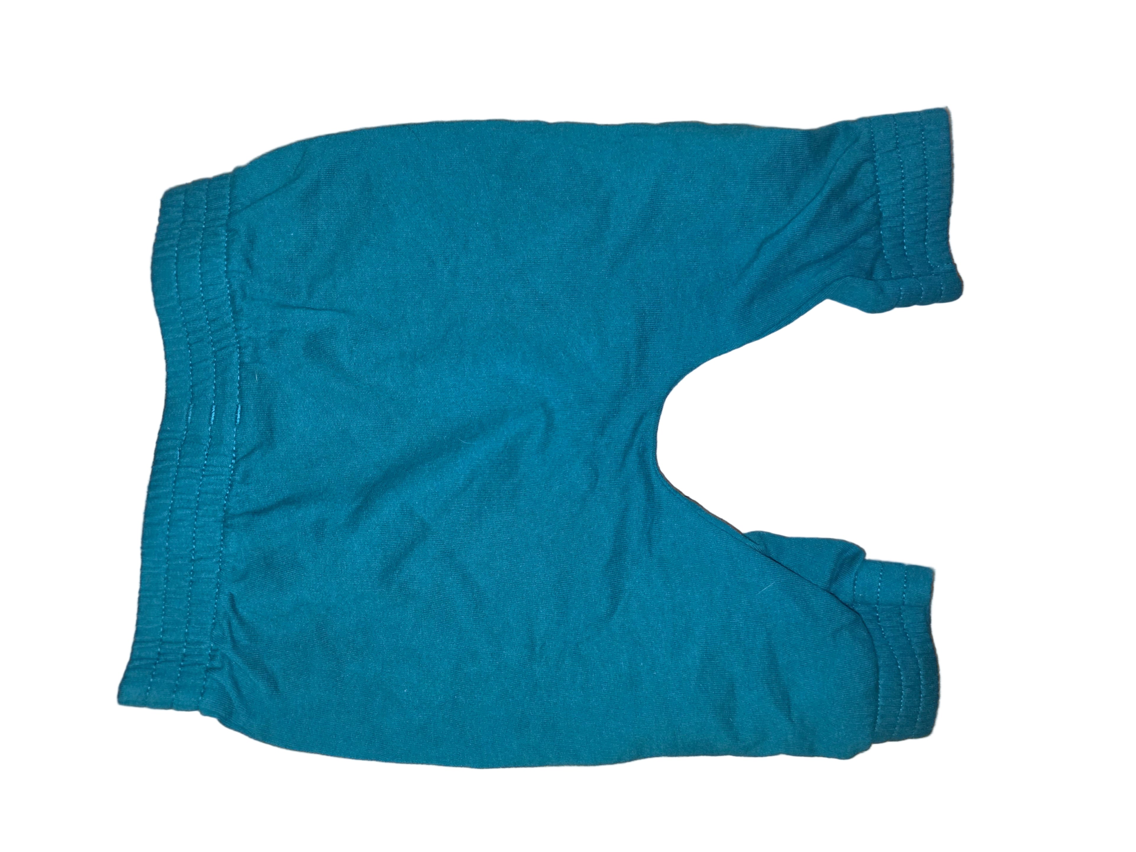 Teal sweater on a wooden floor