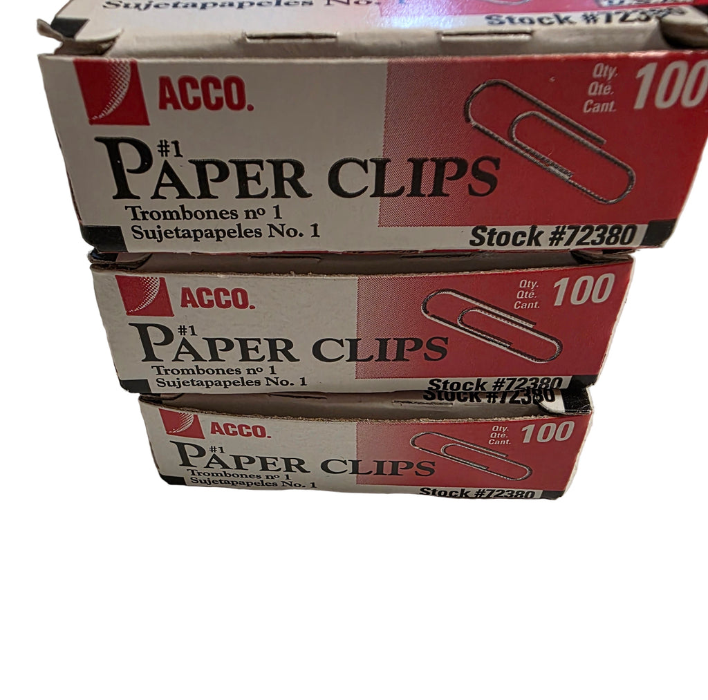 Three boxes of Acco paper clips on a white surface