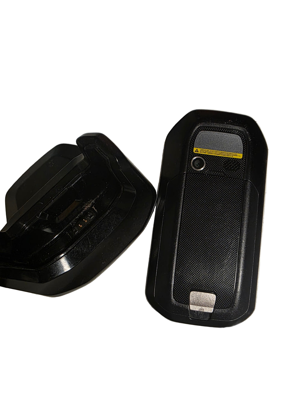 Two black plastic components on a textured metal surface